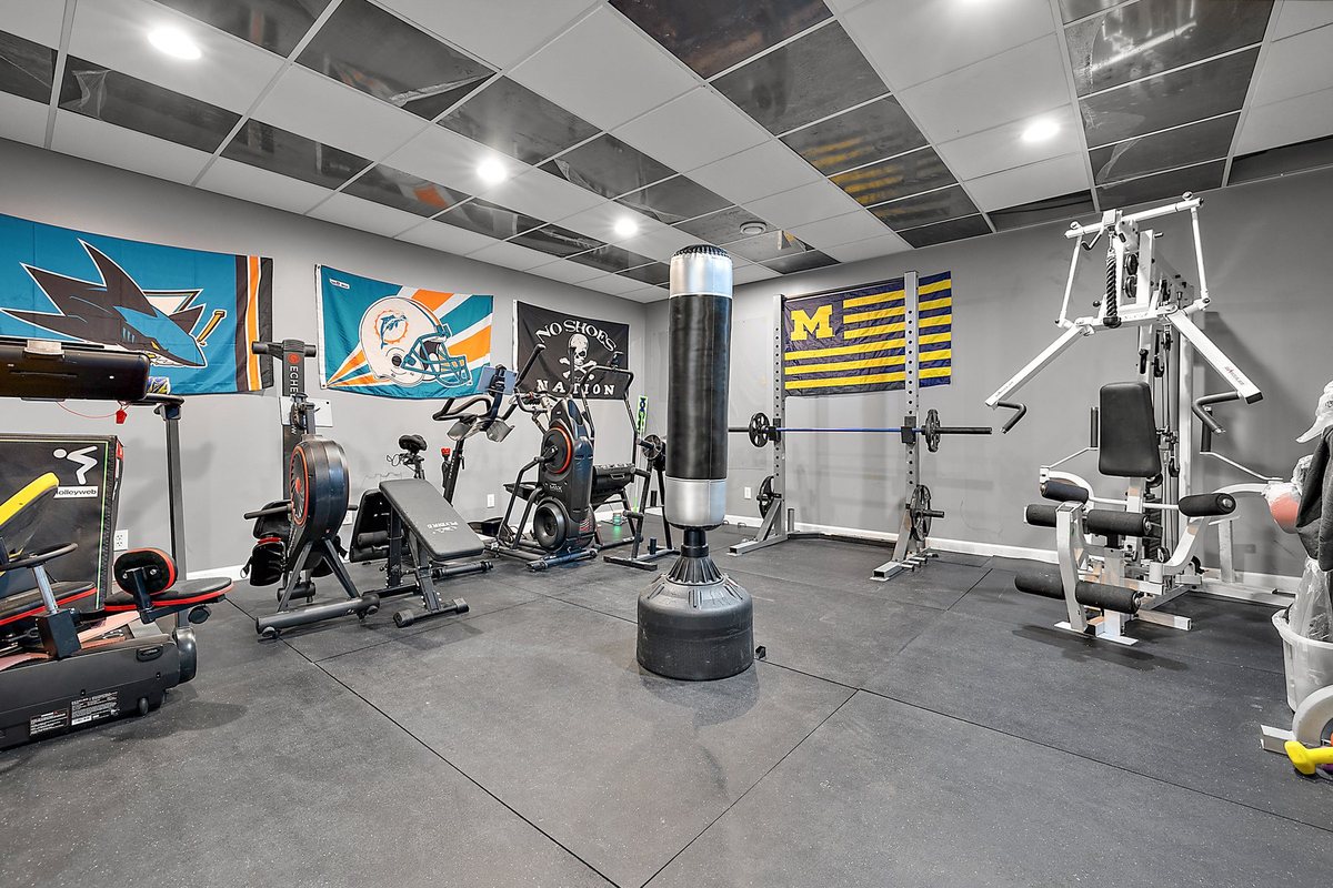Finished exercise room with clean floor and ceiling work.