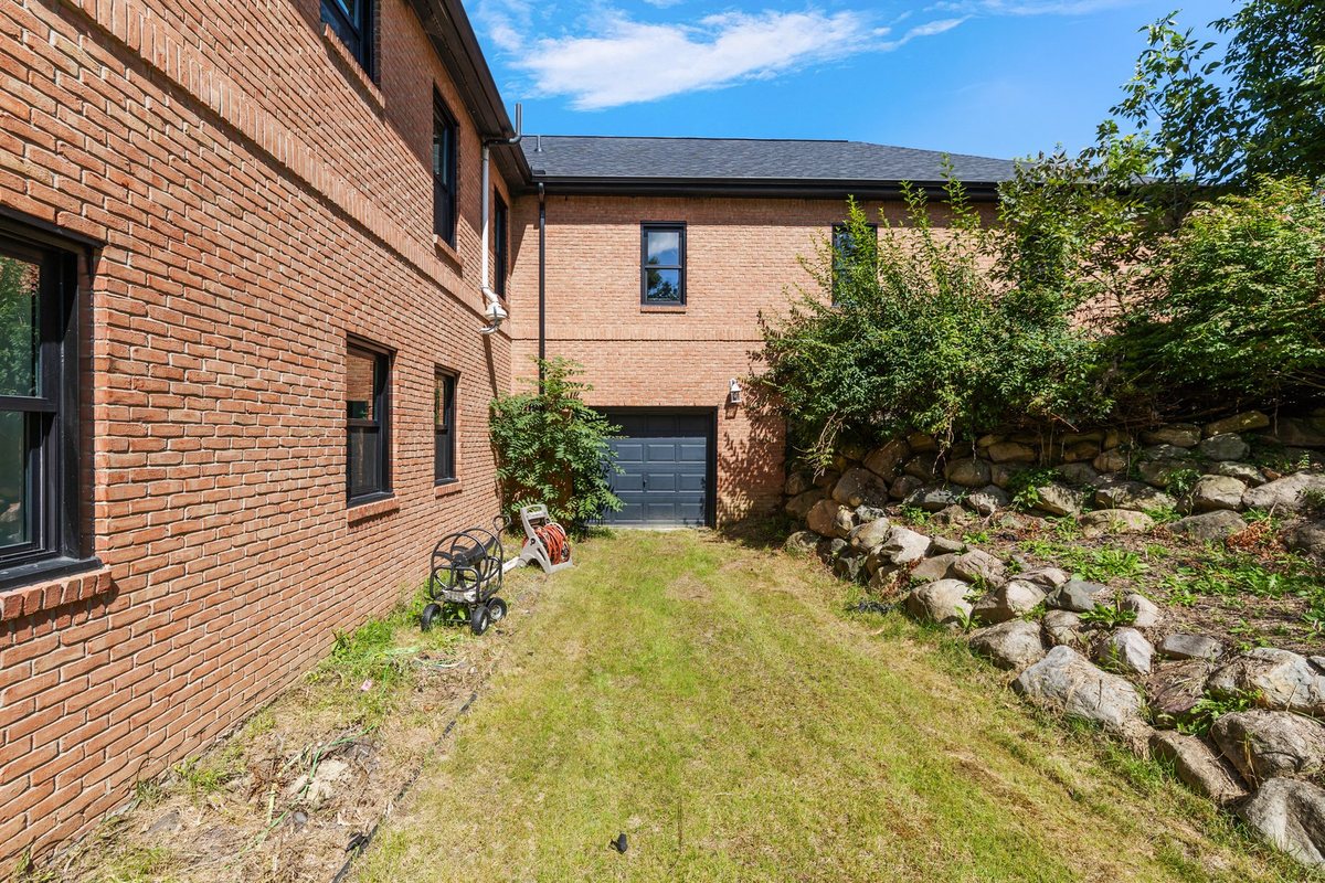 Side yard and exterior wall view.
