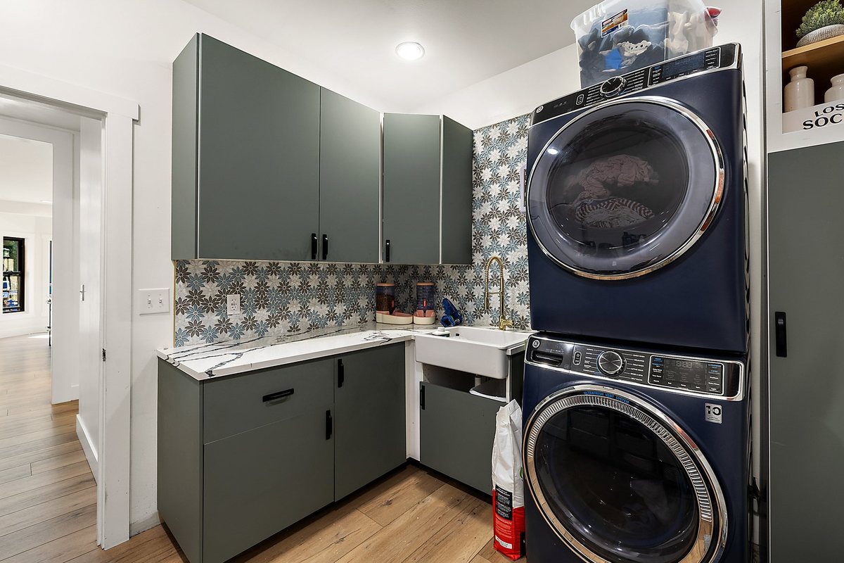 Laundry area with built-in storage and appliance connections.