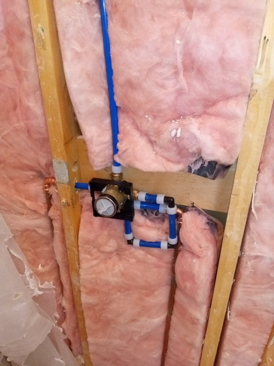 Open wall plumbing rough-in during repair work.