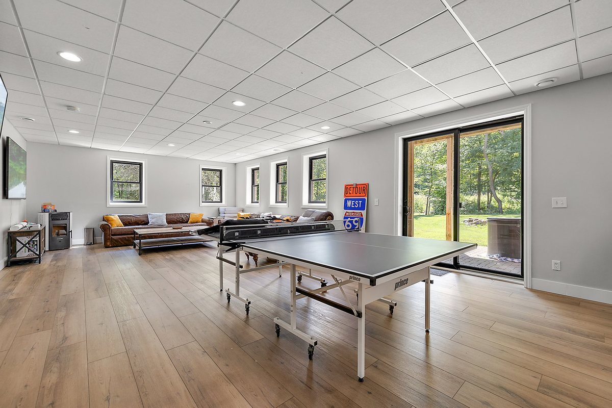 Open lower-level room with finished floor and ceiling.
